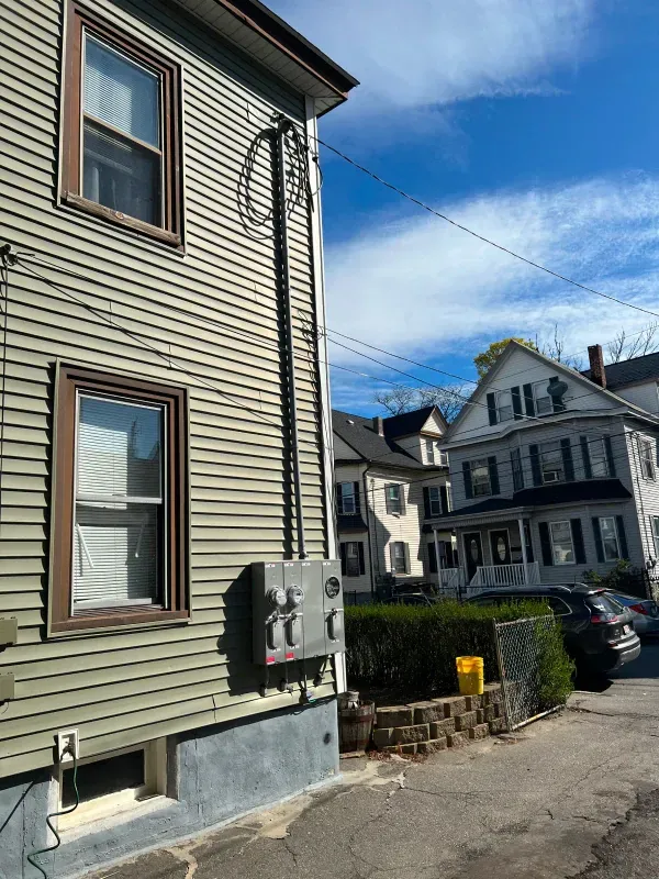 A house with a telephone box on the side of it.