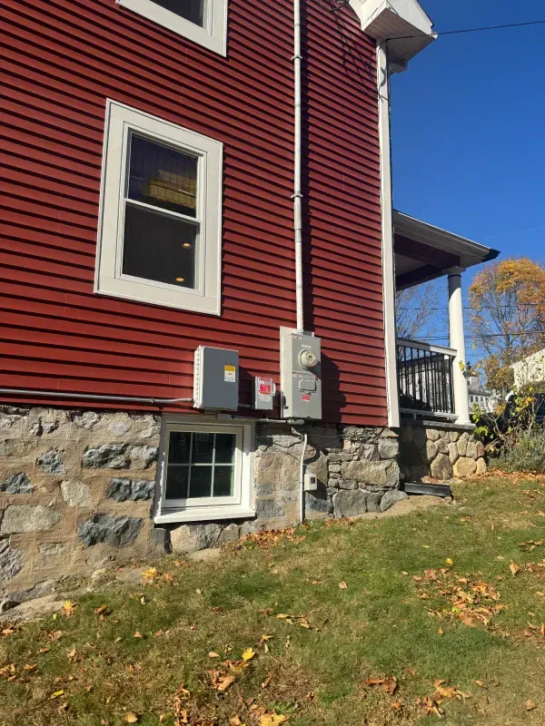A red house with a white trim and a window