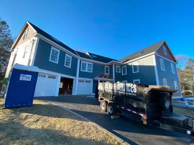 A large house with a trailer parked in front of it.