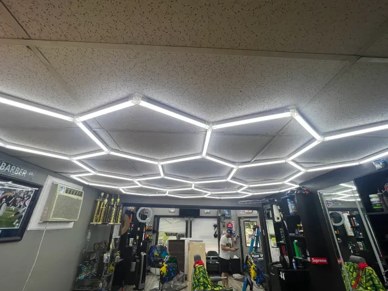 A barber shop with a ceiling that looks like a honeycomb.