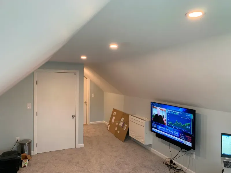 A room with a flat screen tv mounted on the wall.