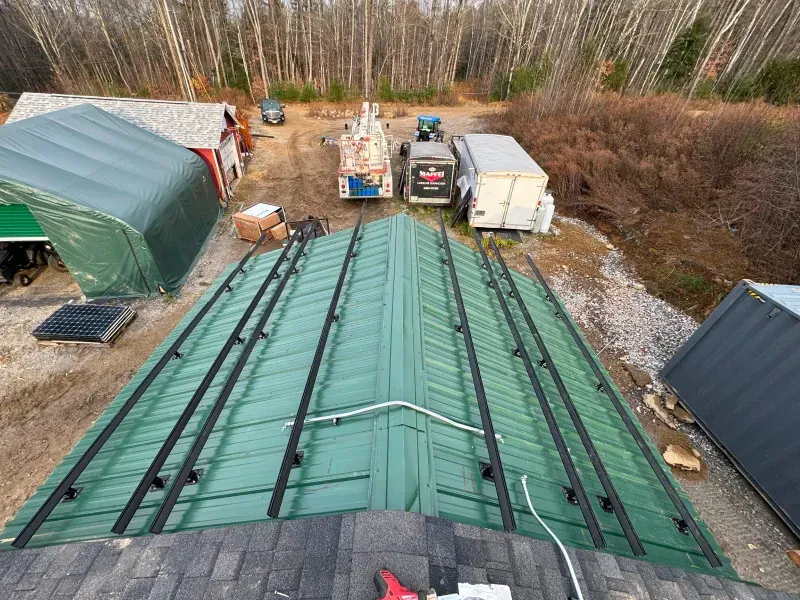 An aerial view of a green roof with solar panels on it.
