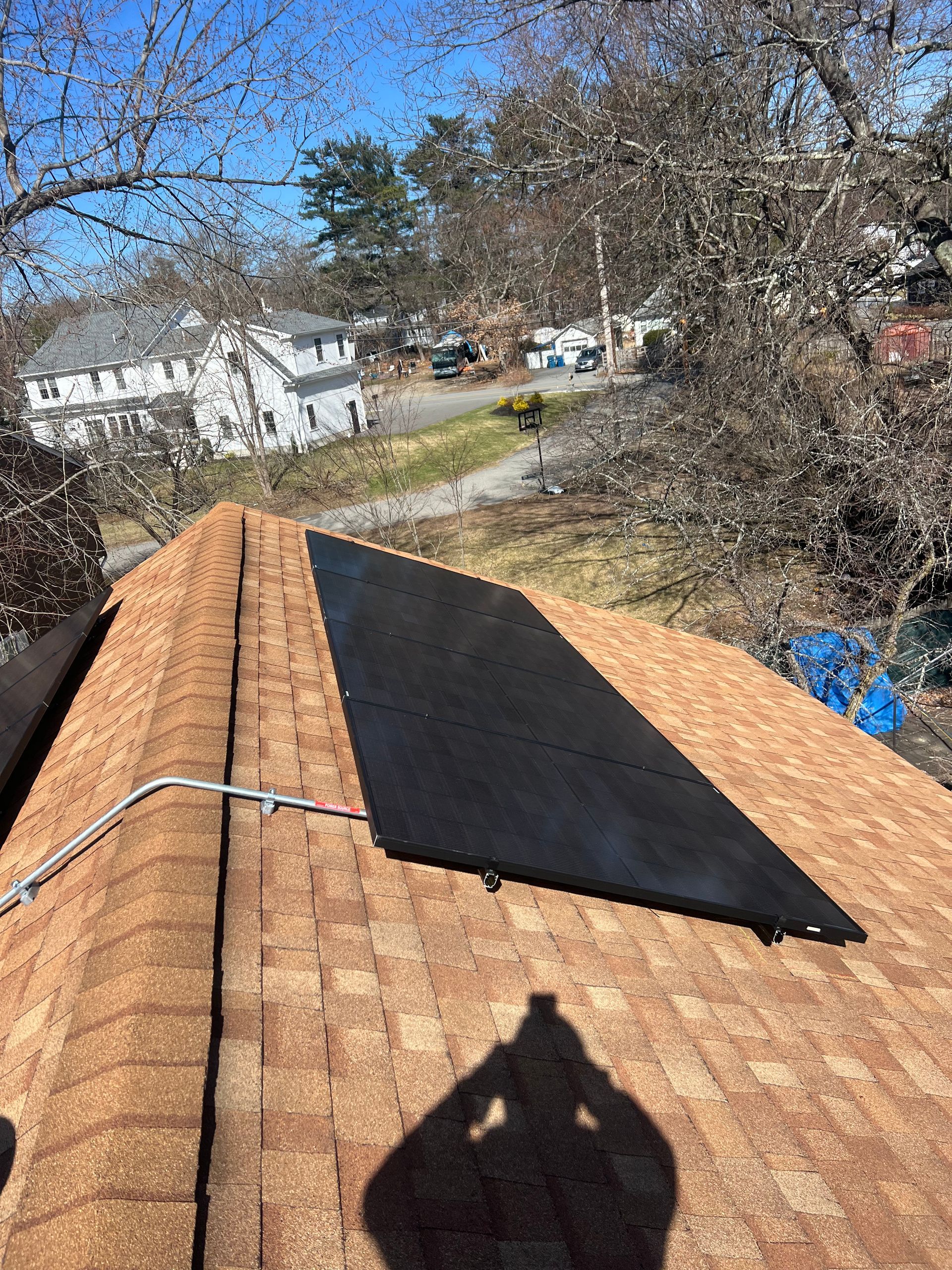 A solar panel is sitting on top of a roof.