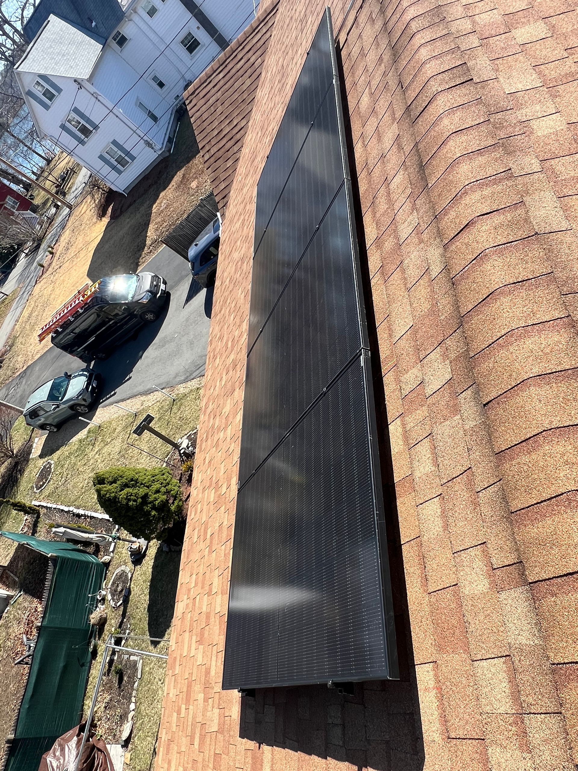 A large solar panel is sitting on top of a roof.