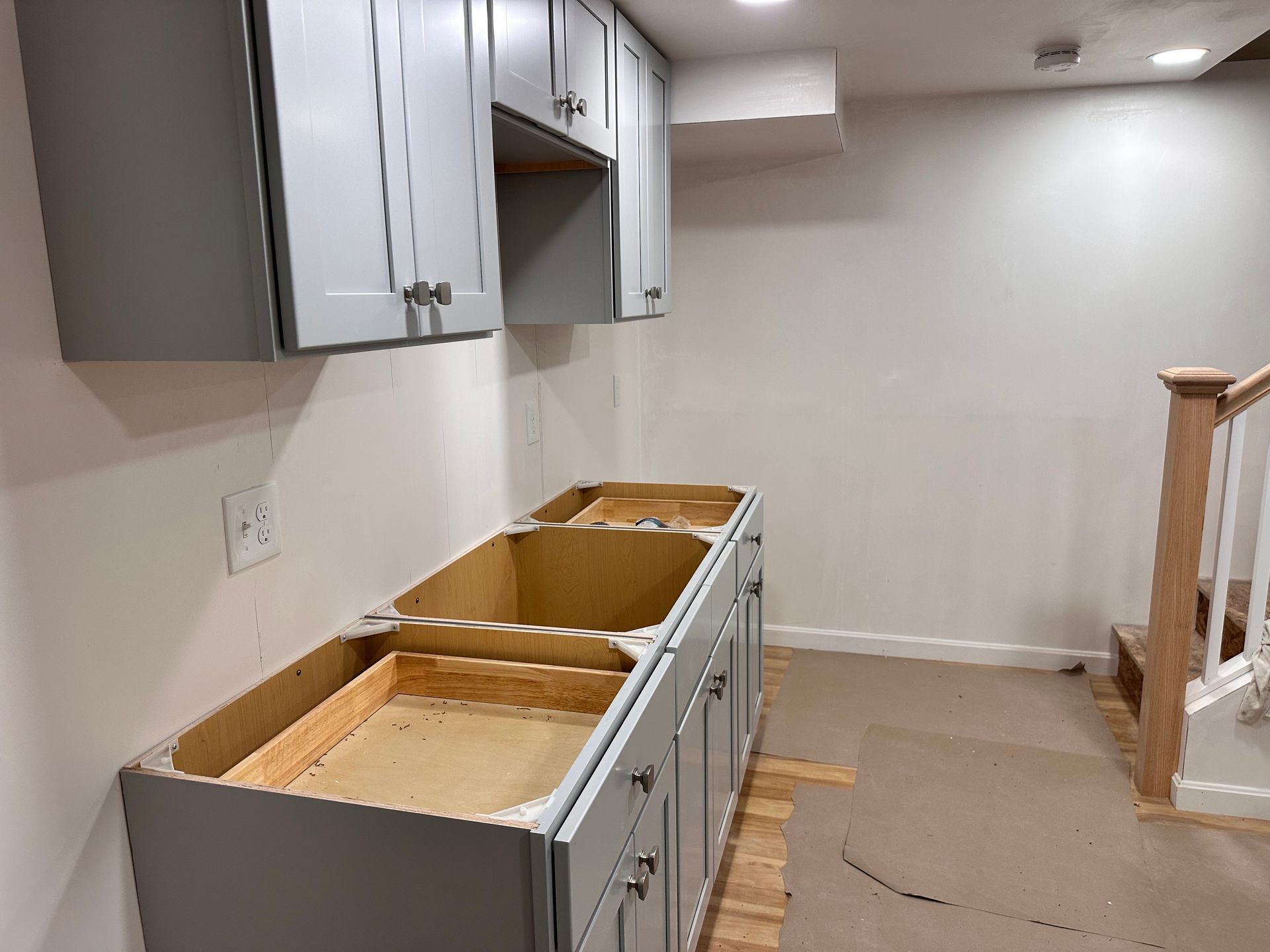 A kitchen with a sink and cabinets is being remodeled.