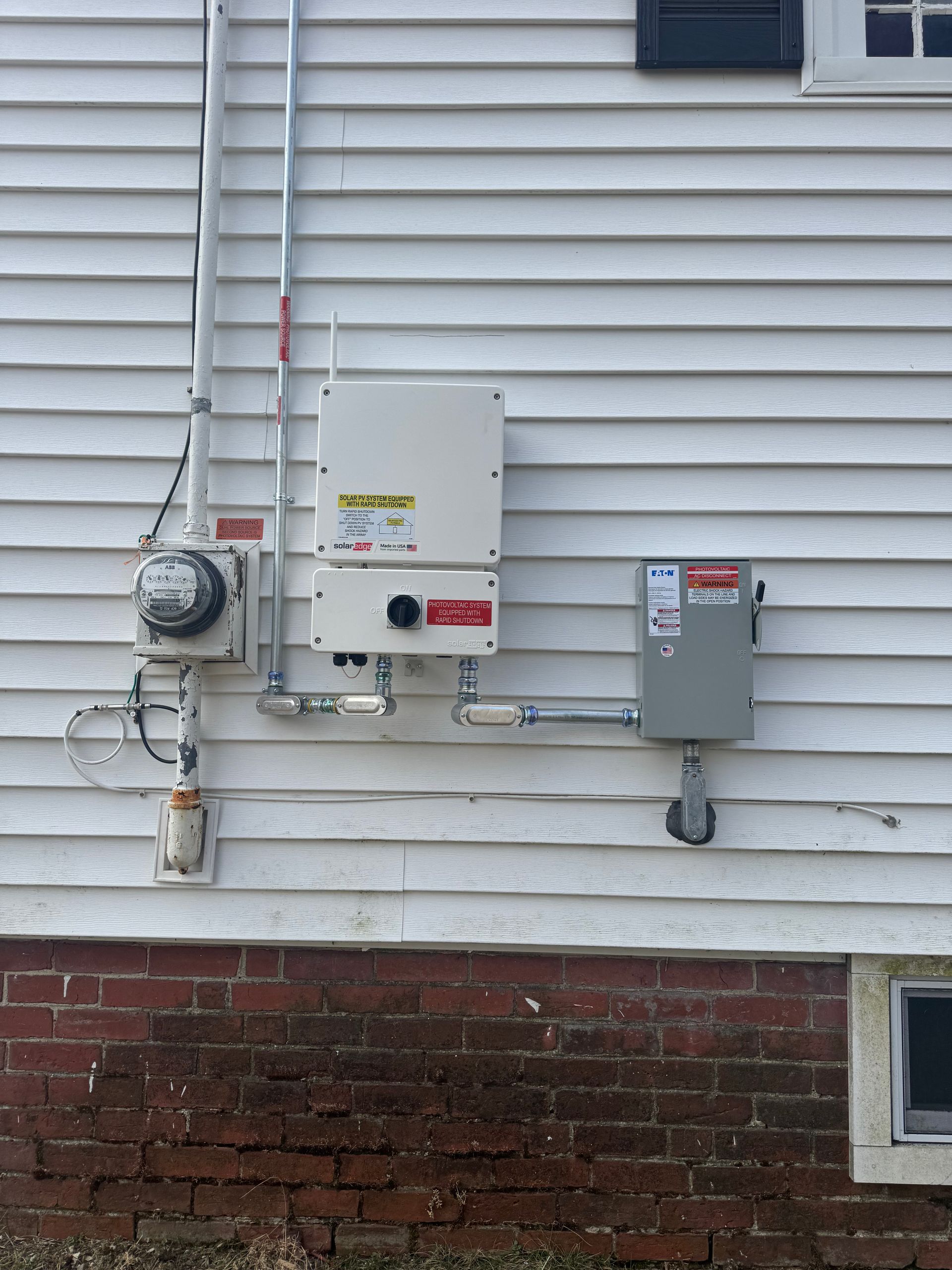 A solar panel is installed on the side of a house.