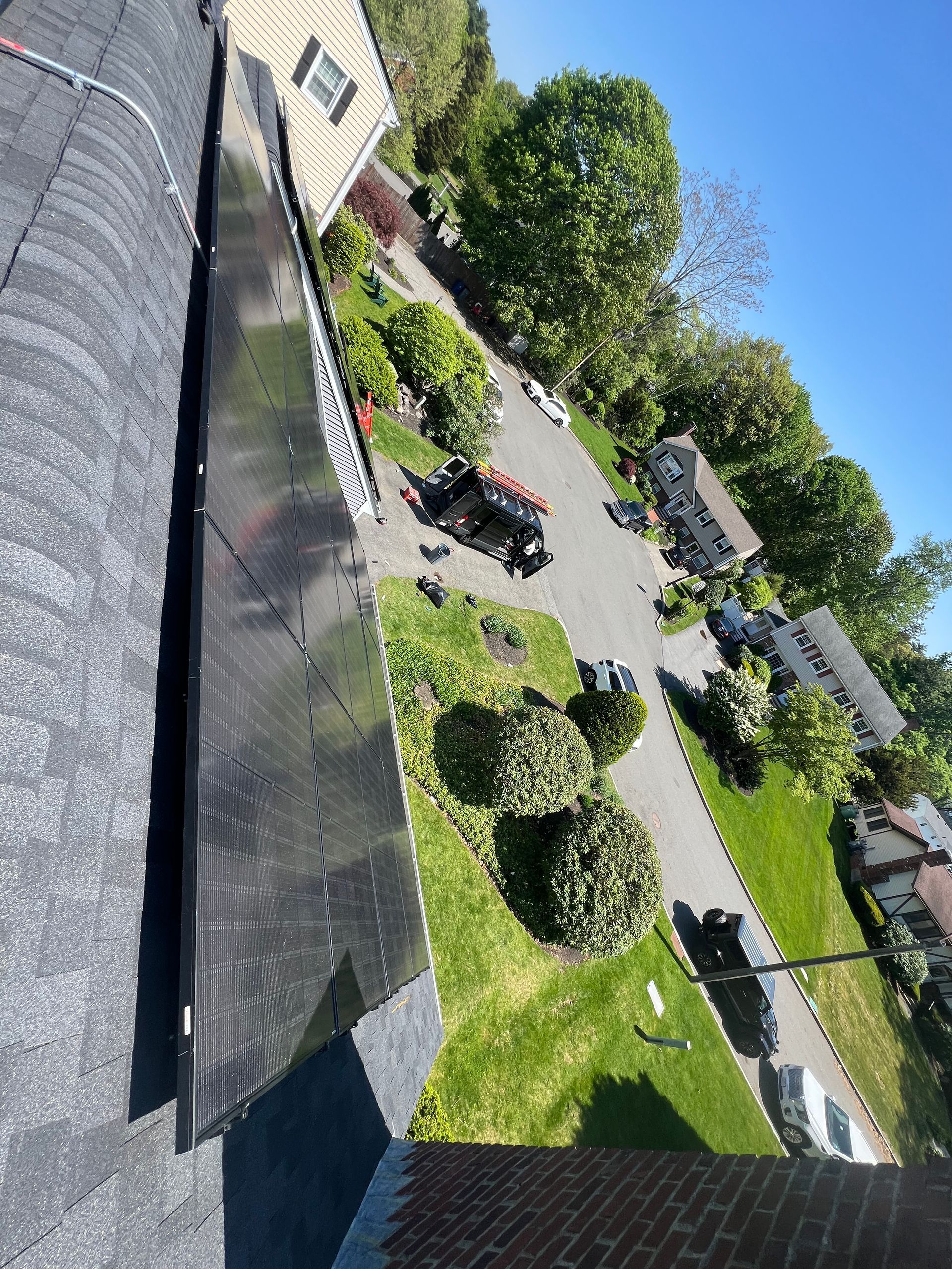 An aerial view of a roof with a solar panel on it.