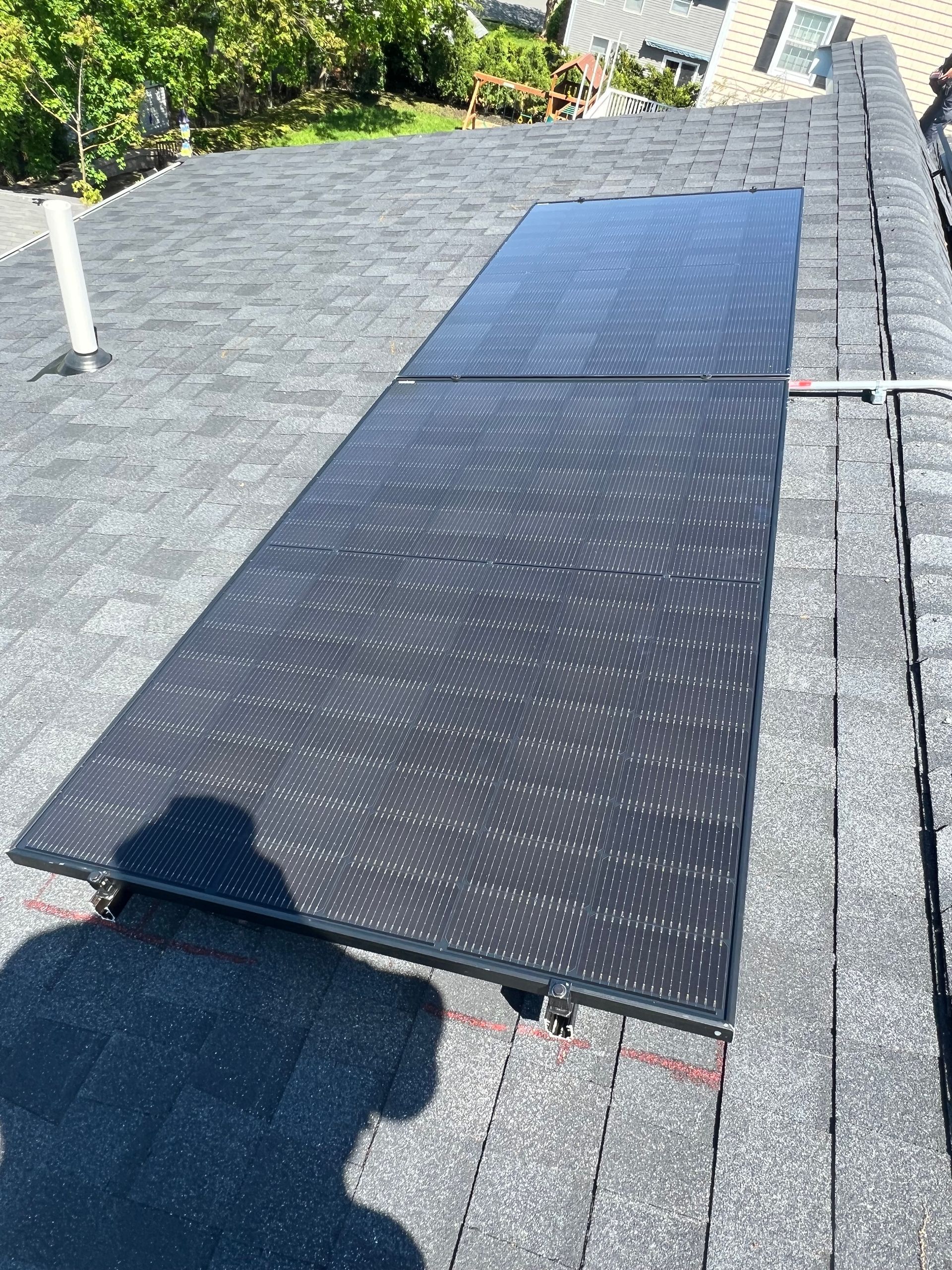 A solar panel is sitting on top of a roof.