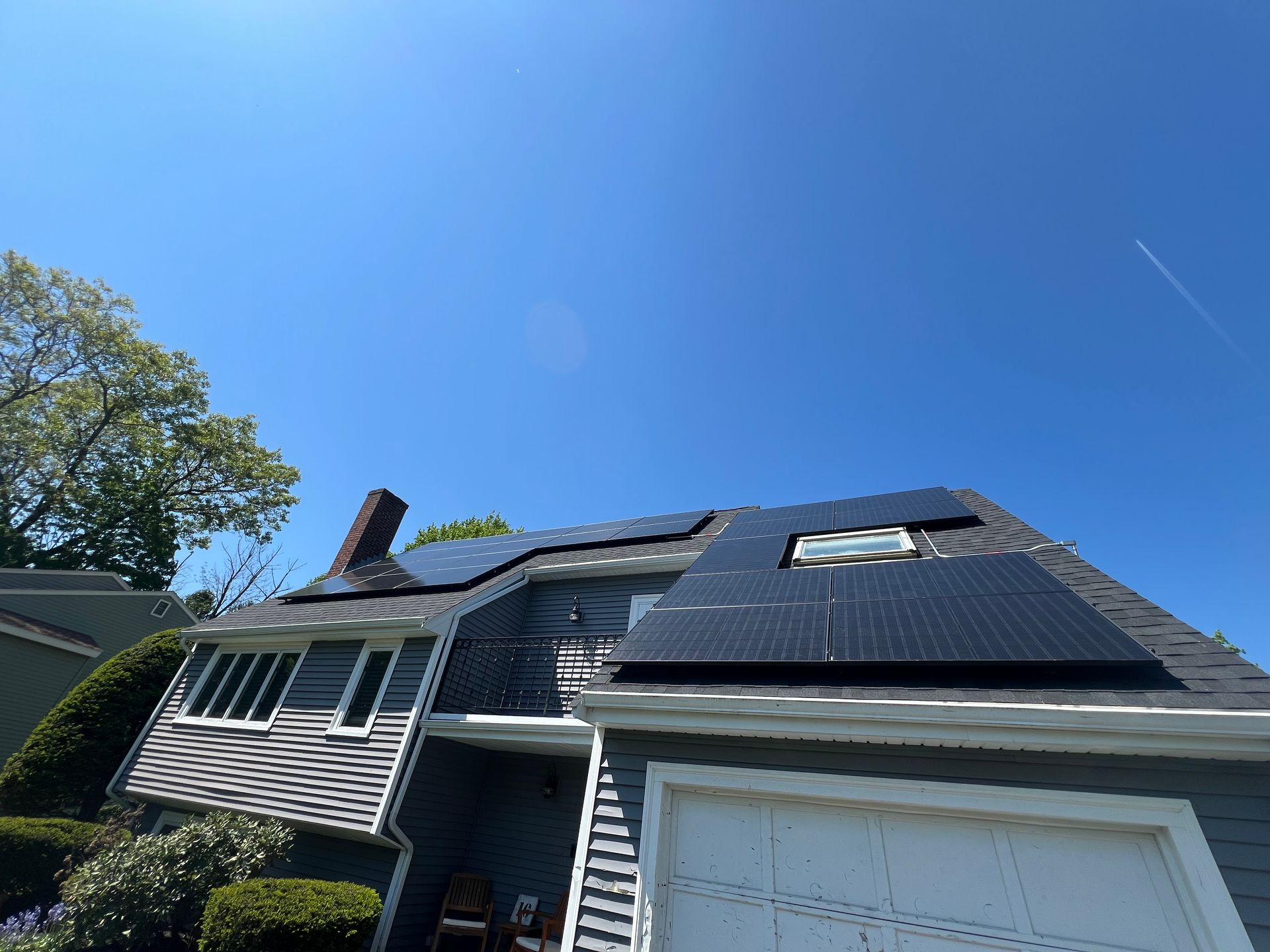 A house with a lot of solar panels on the roof.