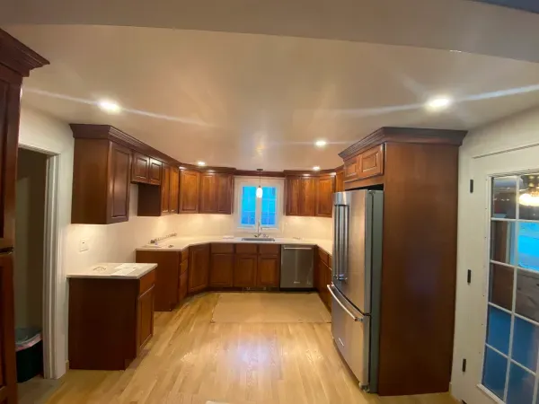 A kitchen with wooden cabinets and stainless steel appliances