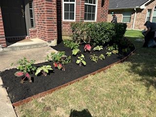 A brick house with a garden in front of it.
