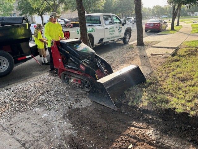 A man is using a tractor to dig a hole in the ground