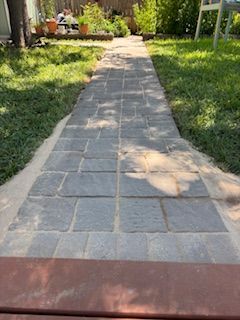 Stone paver pathway through grass.