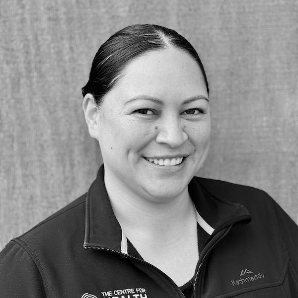 A woman is smiling in a black and white photo.
