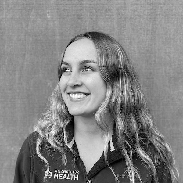 A black and white photo of a woman wearing a shirt that says the centre for health.