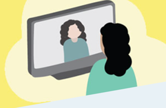 A woman is sitting in front of a television looking at her reflection.