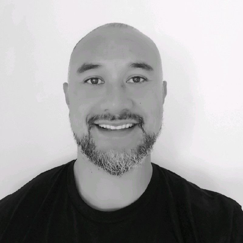 A black and white photo of a man wearing a black shirt.