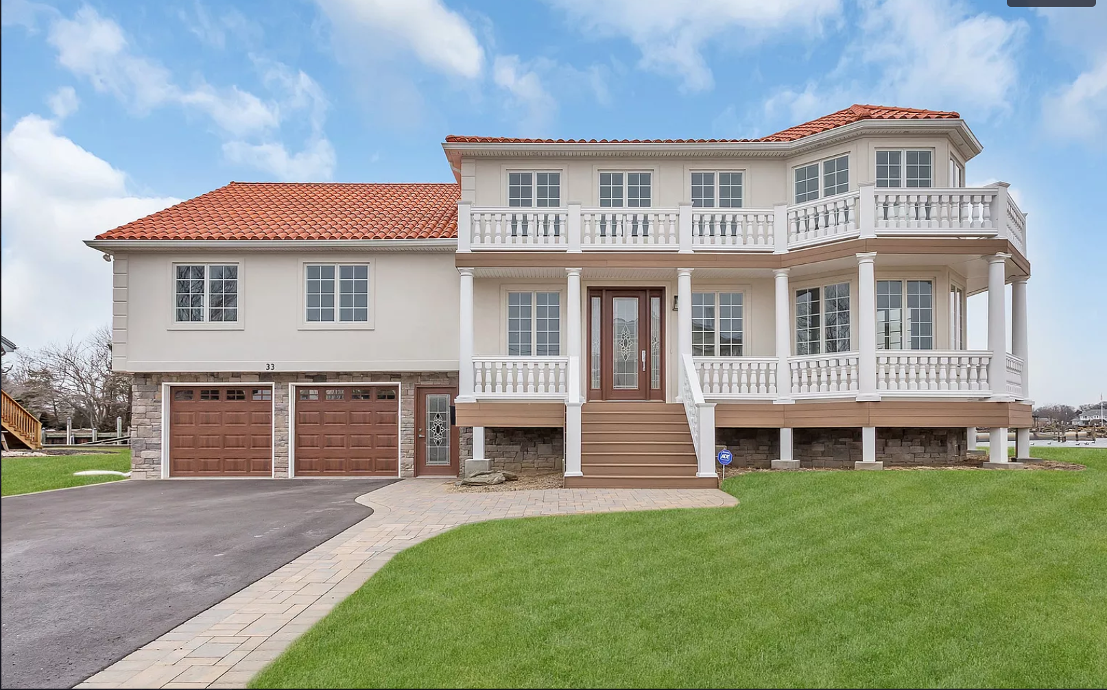 A large white house with a red tile roof