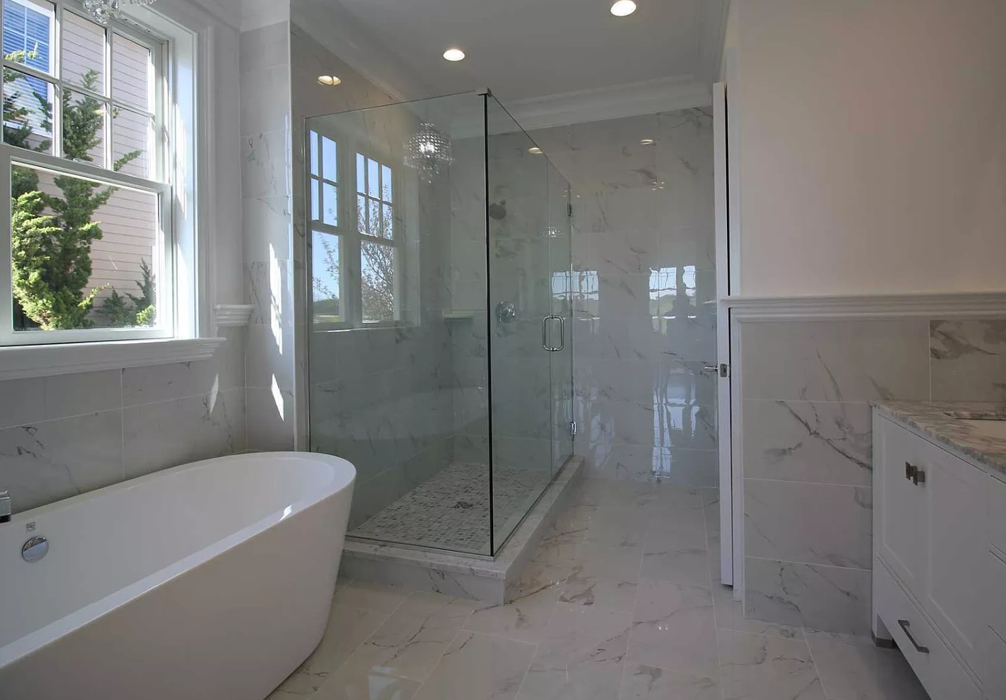 A bathroom with a bathtub and a walk in shower.