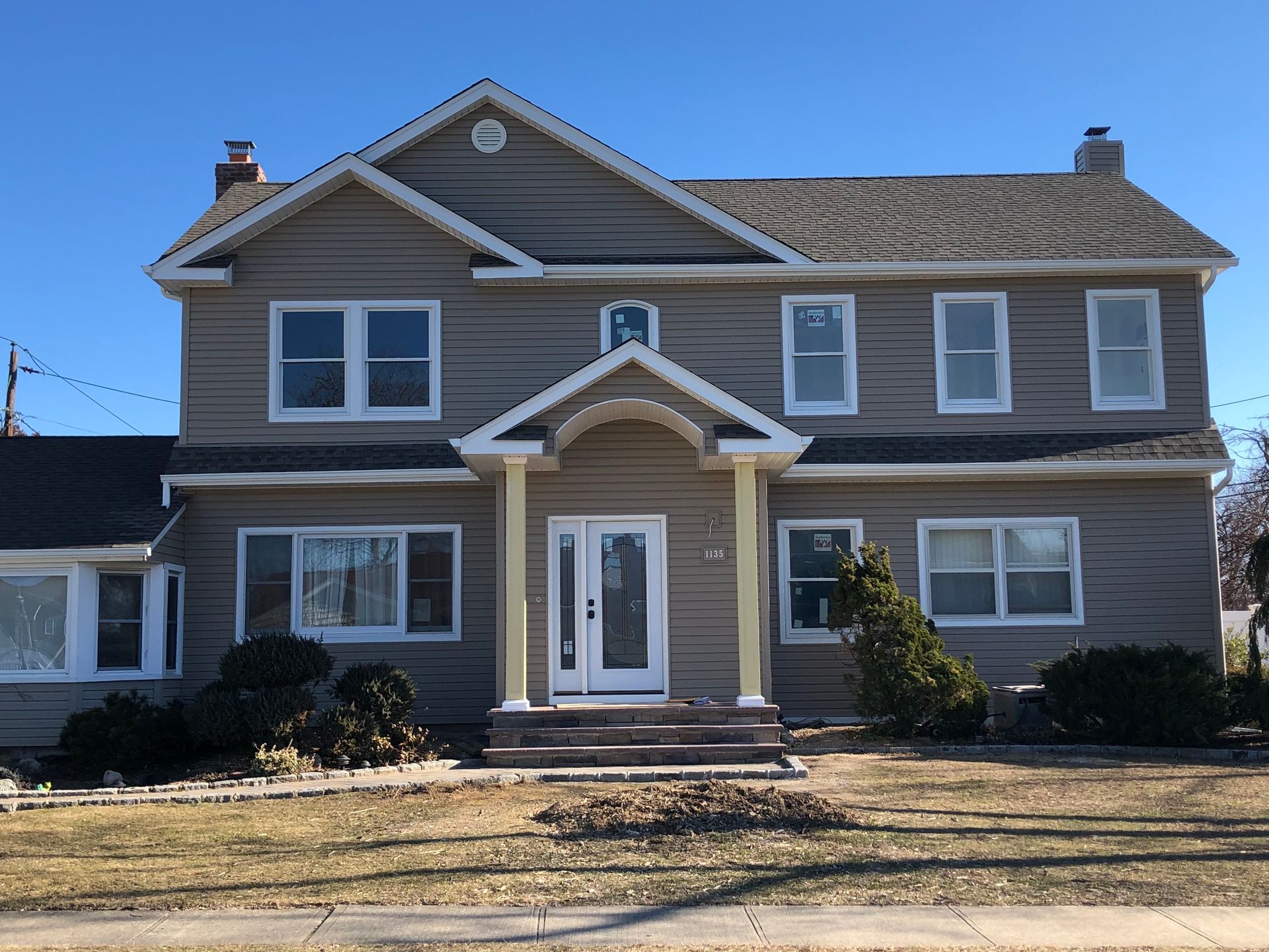 A large house with a lot of windows on a sunny day
