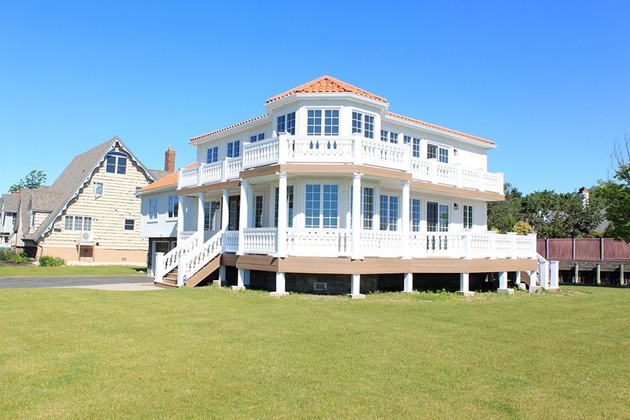 A large white house with a lot of windows and balconies