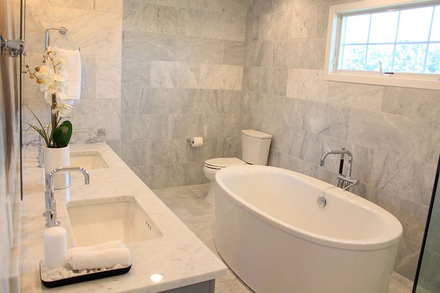 A bathroom with a tub , sink , toilet and shower.
