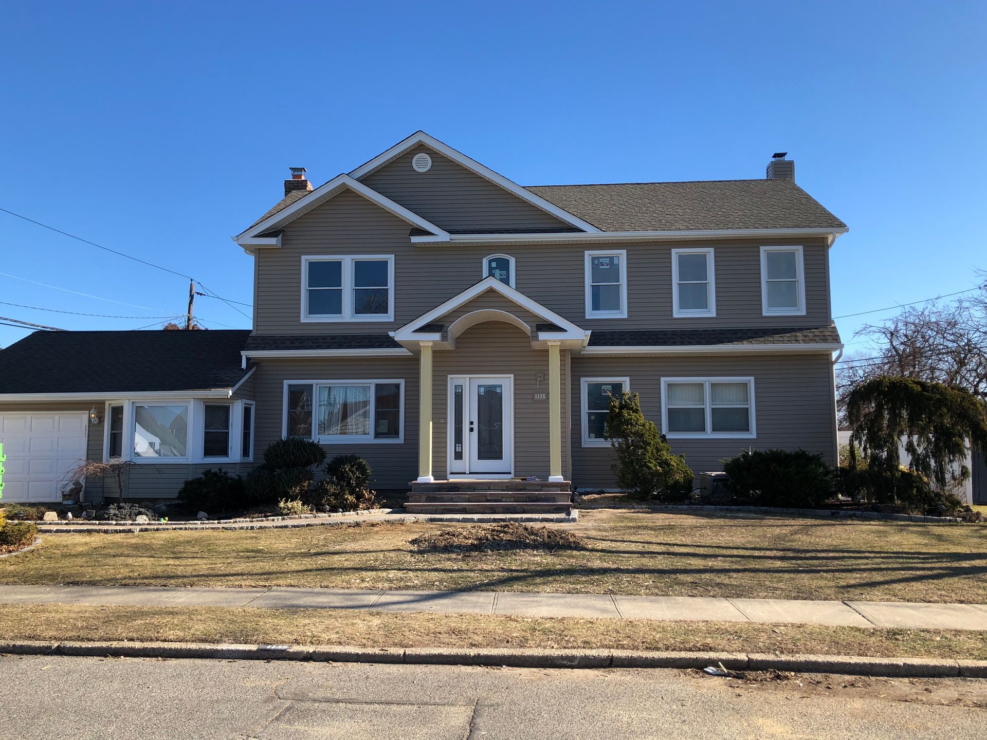 A large house with a blue sky in the background