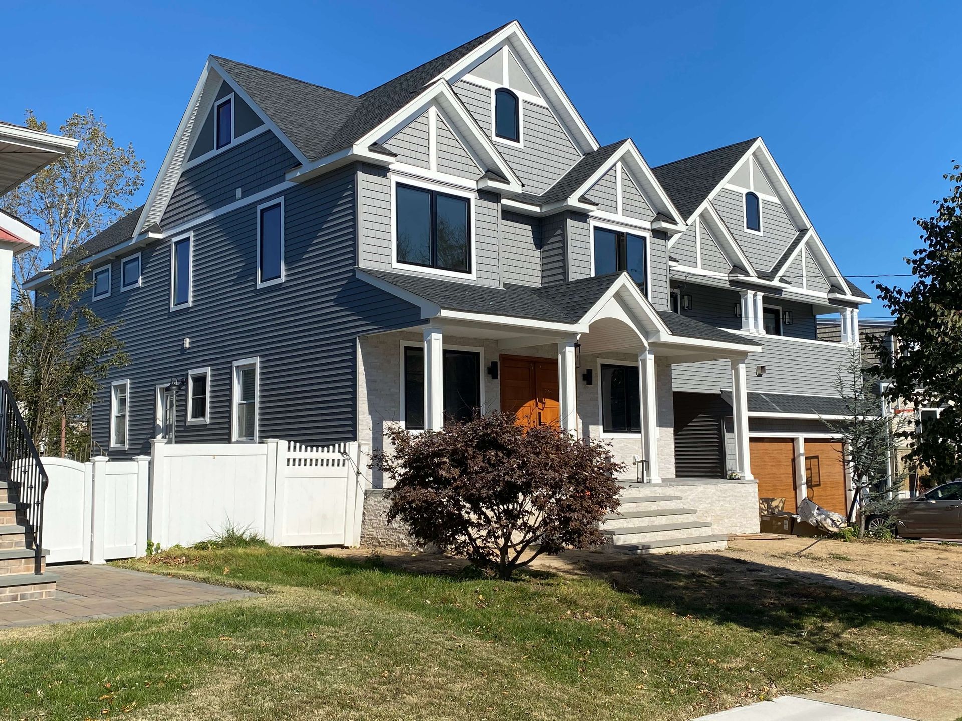 A large house with a white fence in front of it