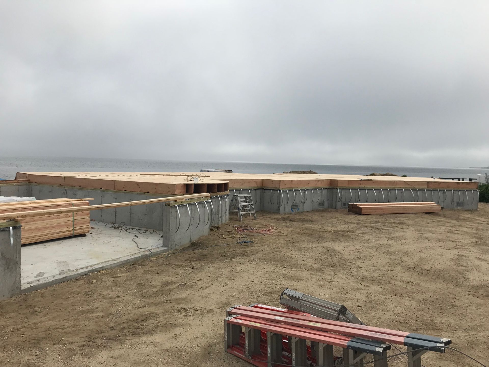 A building under construction with a view of the ocean.