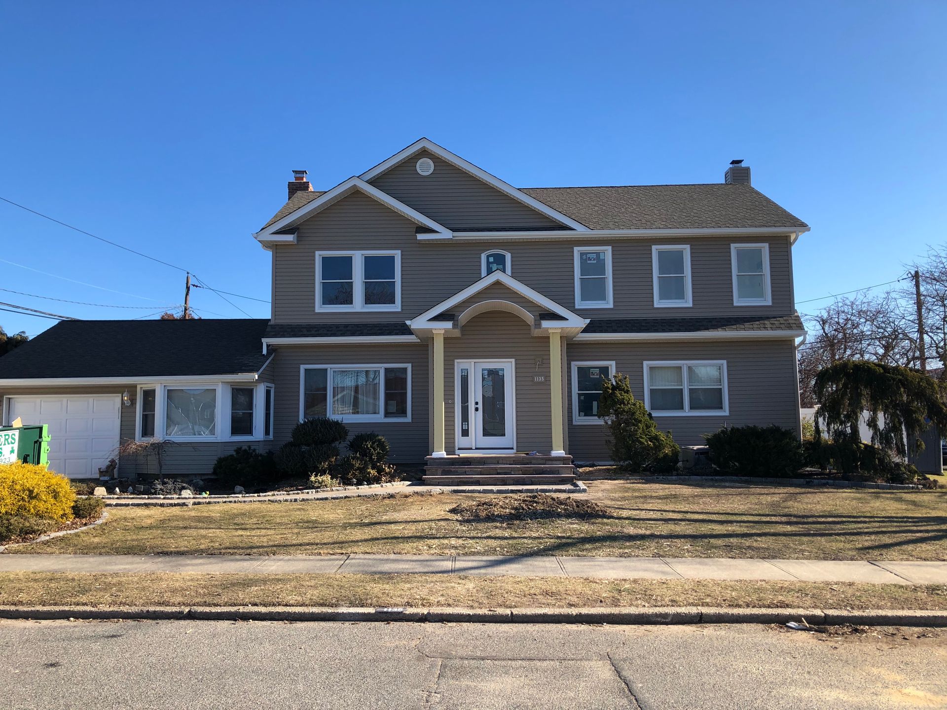 A large house with a lot of windows on a sunny day