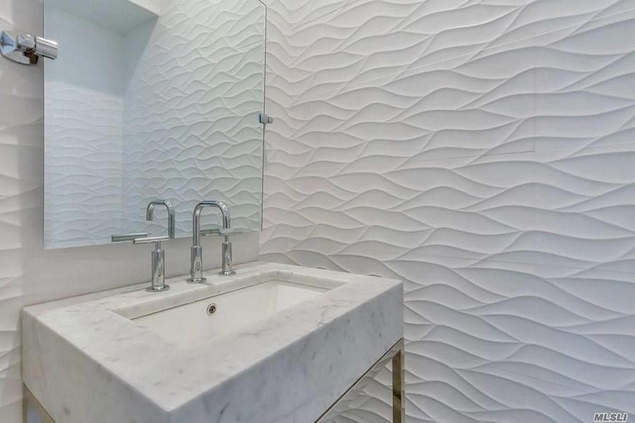 A bathroom with a sink and a mirror.