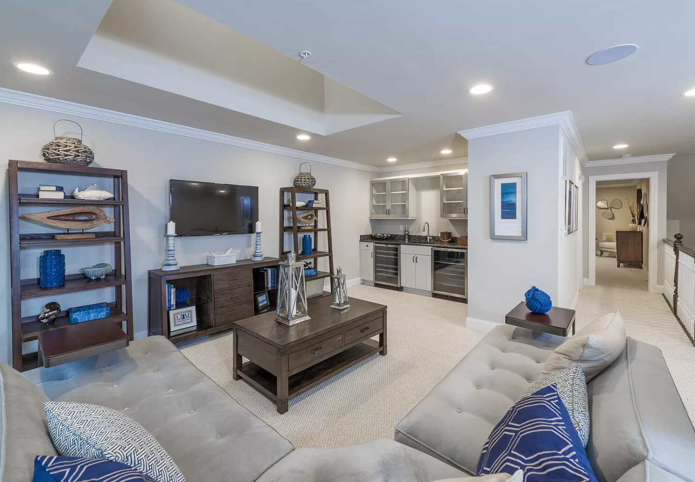 A living room with a couch , coffee table , and television.