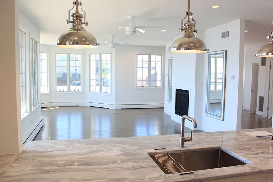 A kitchen with a sink and a lot of windows