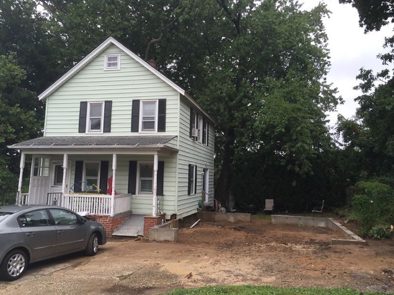A house with a car parked in front of it