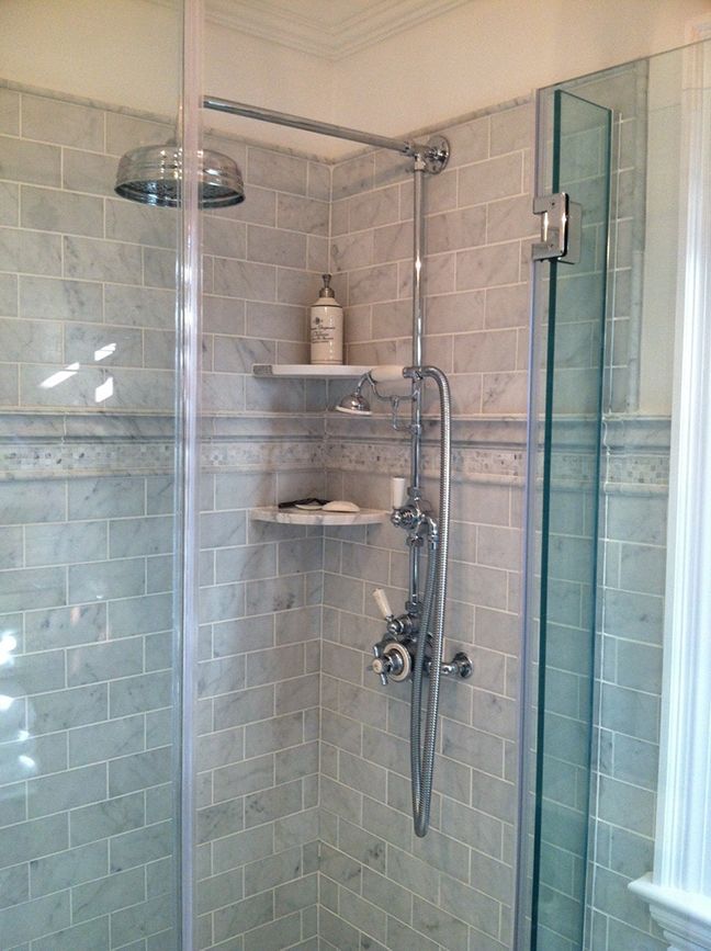 There is a shower with a glass door and a shower head.