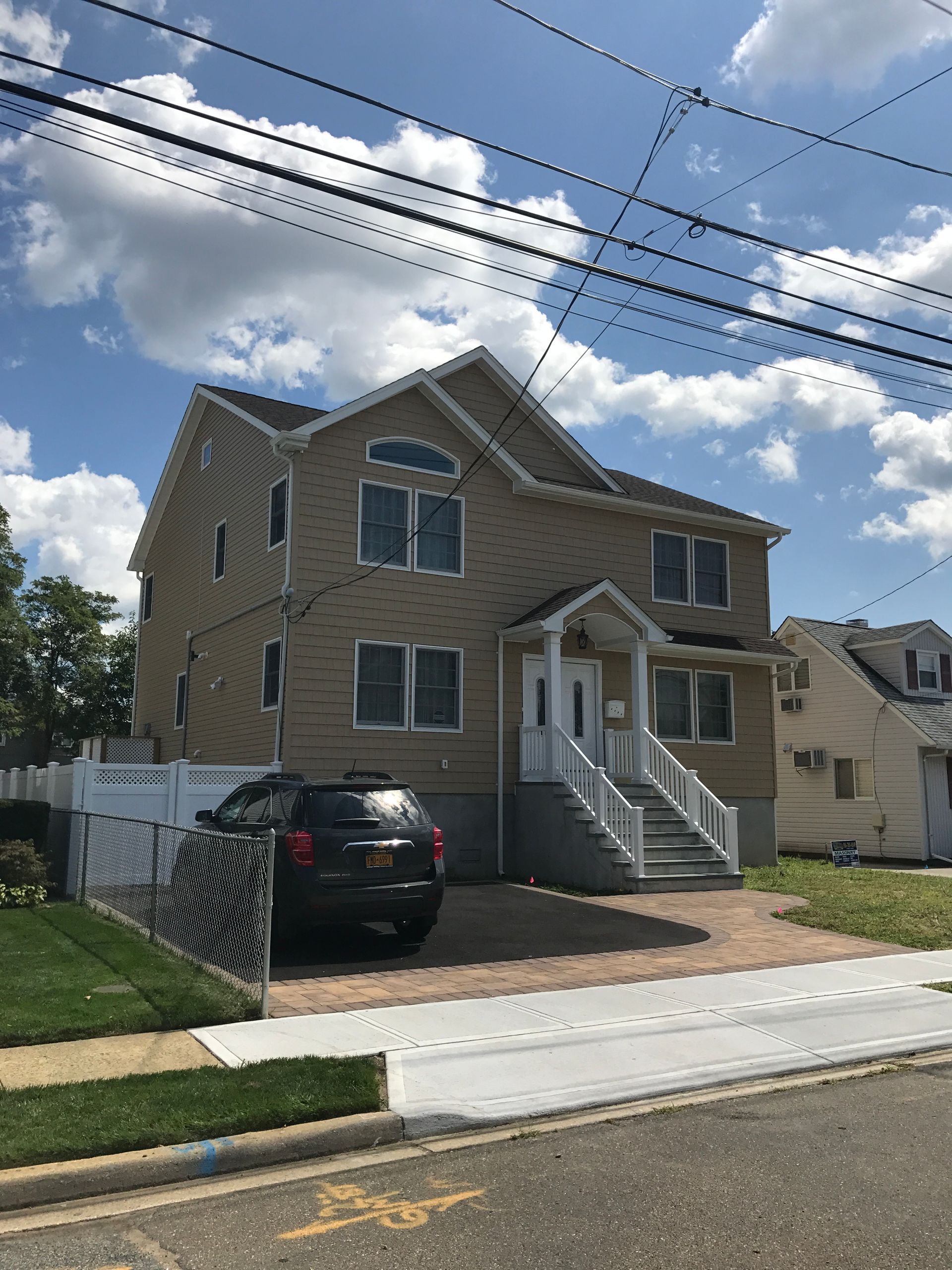 A large house with a car parked in front of it