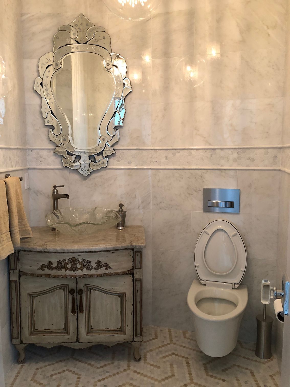 A bathroom with a toilet , sink and mirror