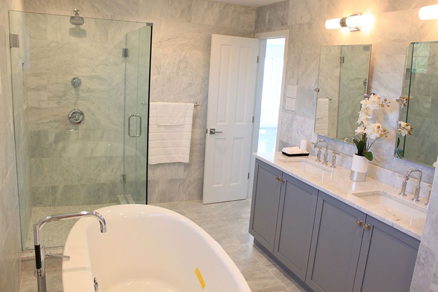 A bathroom with a bathtub and a walk in shower.