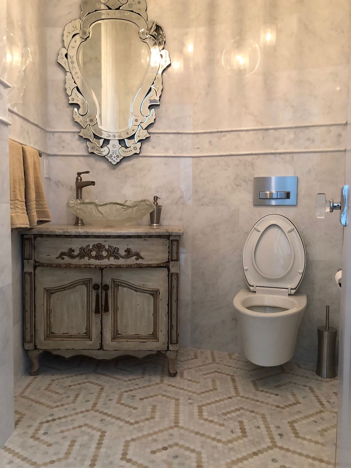 A bathroom with a sink , toilet and mirror.