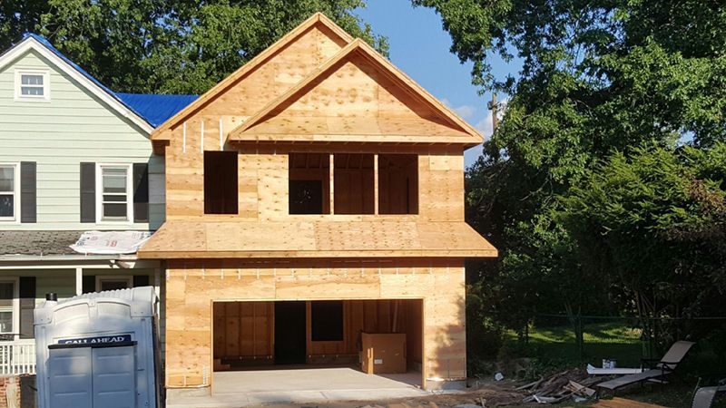 A house is being built with a garage underneath it.
