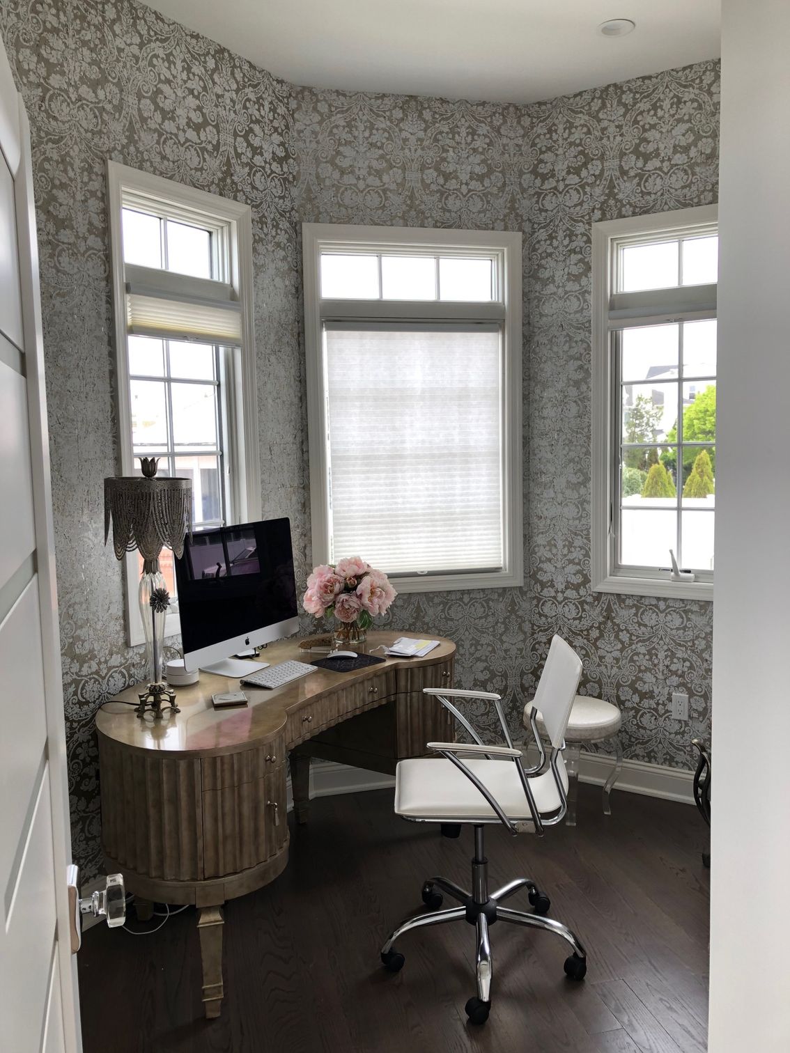 A home office with a desk , chair and computer.