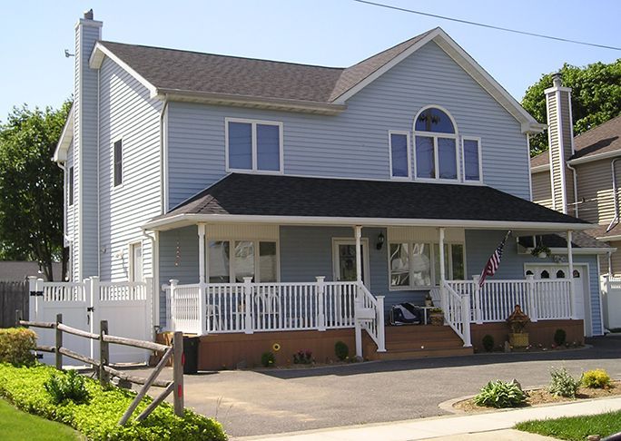 A large white house with a large porch