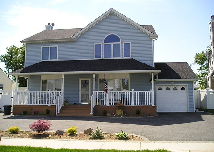 A large house with a porch and a garage