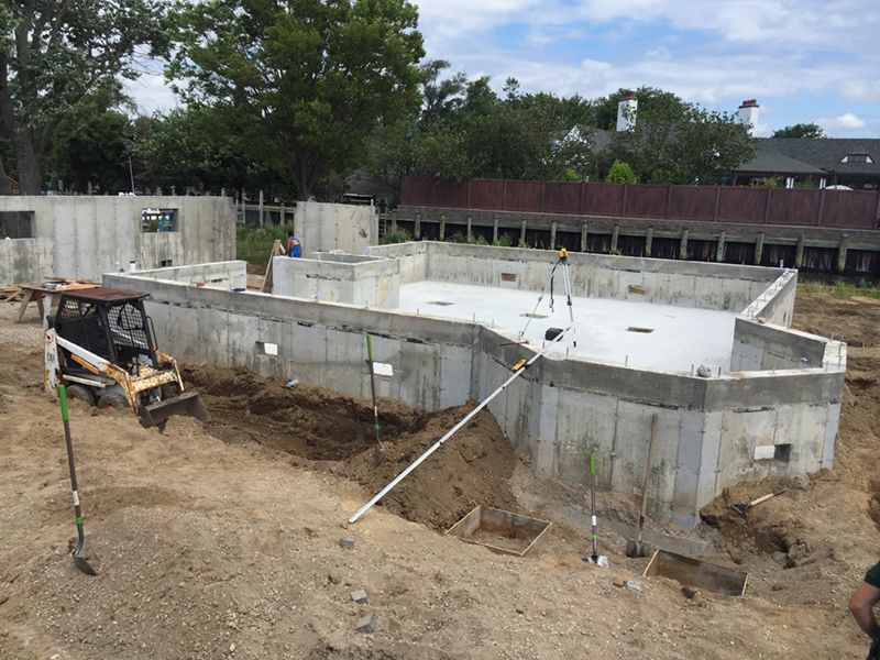 A construction site with a bulldozer and a shovel in the dirt.