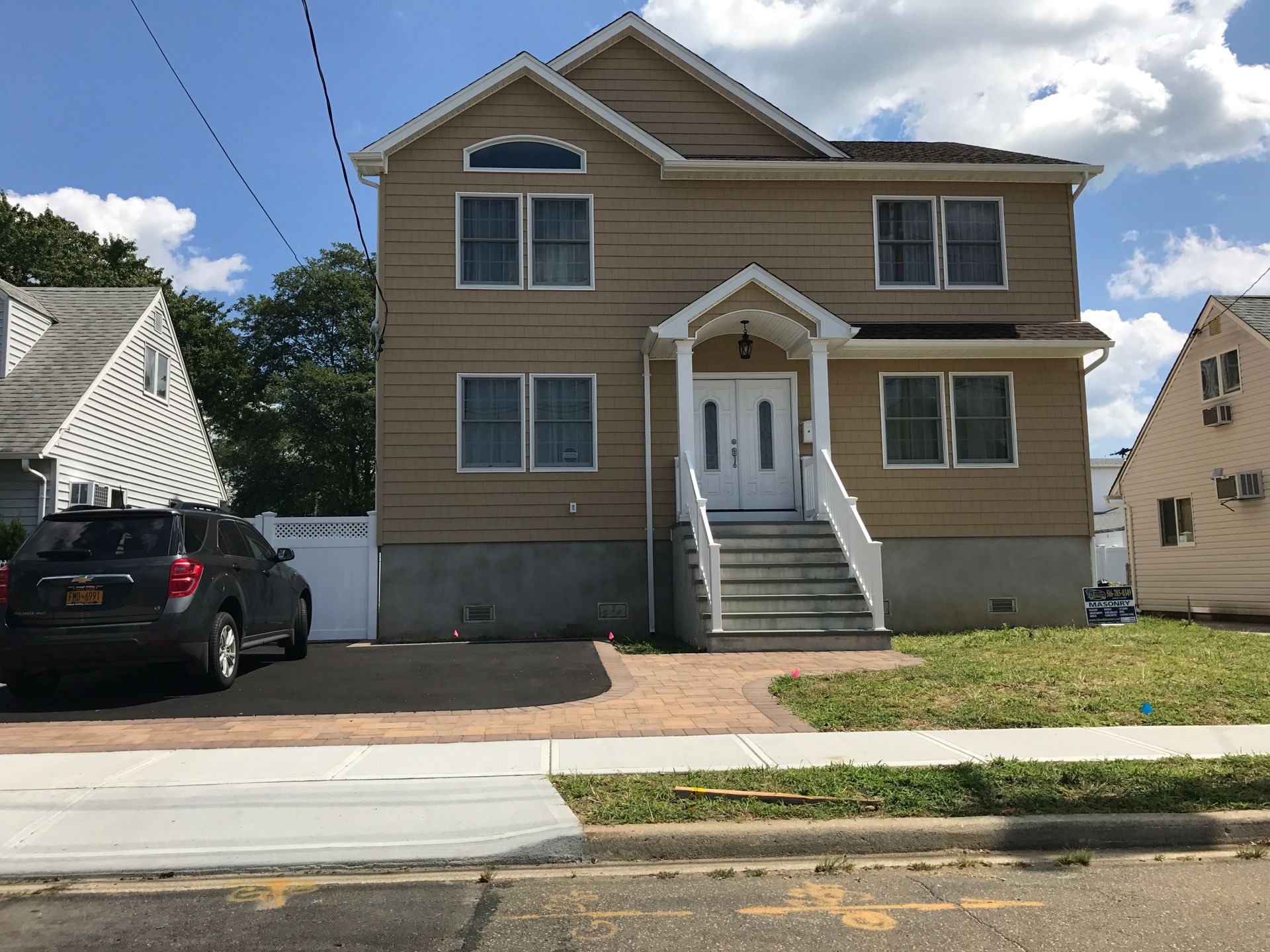 A house with a car parked in front of it