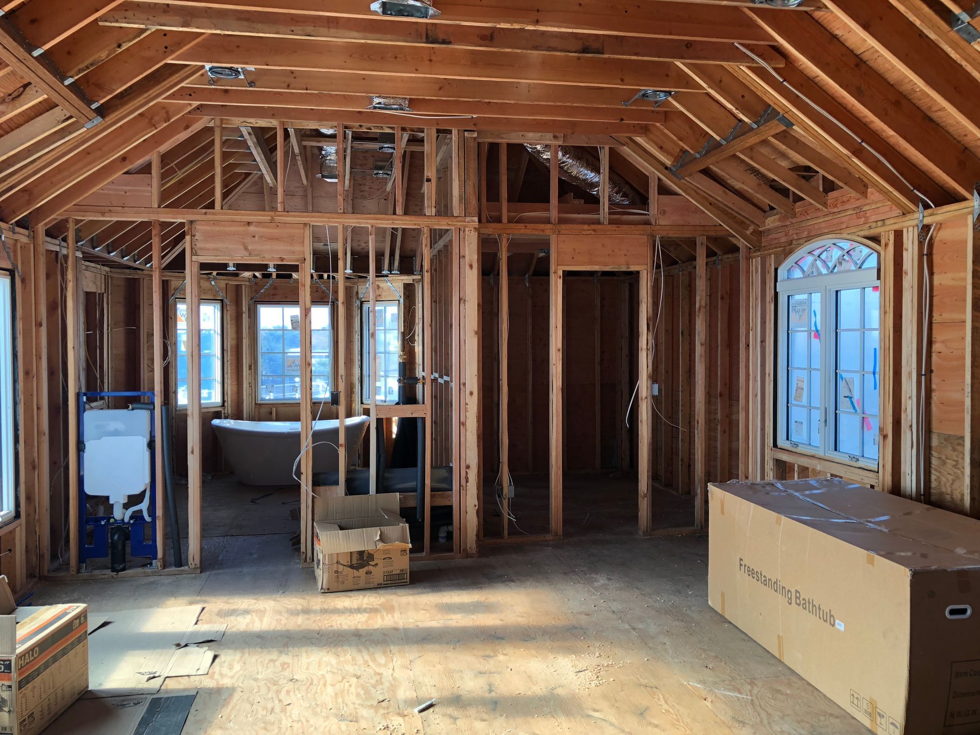 A house is being built with a bathtub in the middle of the room.