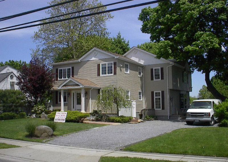 A house with a white van parked in front of it