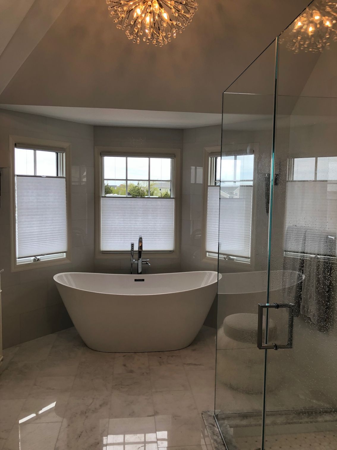 A bathroom with a bathtub and a walk in shower