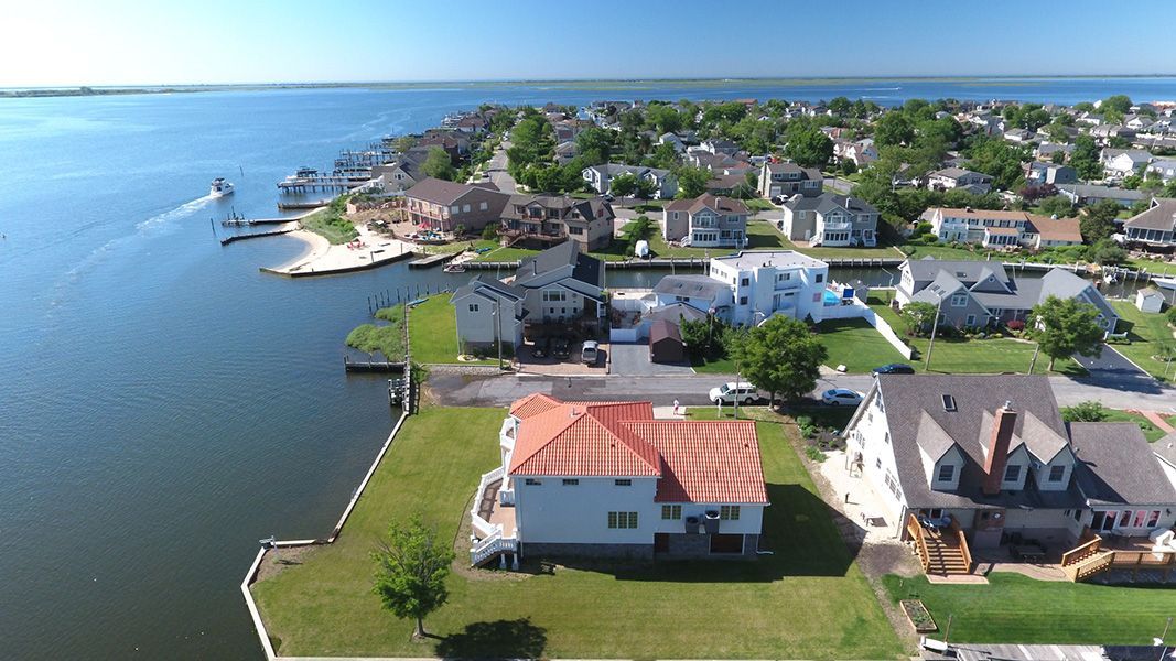 An aerial view of a residential area next to a body of water.