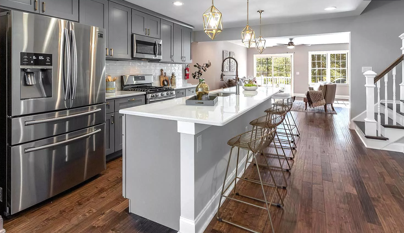 A kitchen with stainless steel appliances and a large island.
